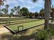 Bocce ball courts surrounded by lush landscaping and comfortable seating areas at 8165 Bridgeport Bay Cir, Mount Dora, FL 32757