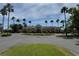 Exterior of clubhouse surrounded by green lawn, palm trees, and circular driveway at 8165 Bridgeport Bay Cir, Mount Dora, FL 32757