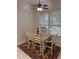 Bright dining room with a dining table set on an area rug under a ceiling fan at 8165 Bridgeport Bay Cir, Mount Dora, FL 32757