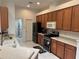 Well-lit kitchen featuring stainless steel appliances and a breakfast bar at 8165 Bridgeport Bay Cir, Mount Dora, FL 32757