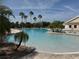 Resort-style pool with palm trees and lounge chairs for relaxing in the sun at 8165 Bridgeport Bay Cir, Mount Dora, FL 32757