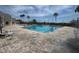 A beautiful swimming pool and deck with ample seating under the clear blue sky at 8165 Bridgeport Bay Cir, Mount Dora, FL 32757