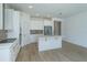 Bright kitchen with stainless steel appliances, a center island, white cabinets, and a stylish backsplash at 990 Fiesta Key Cir, Lady Lake, FL 32159