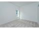 Bright bedroom featuring neutral carpet, a double-paned window, and a closet at 995 Fiesta Key Cir, Lady Lake, FL 32159