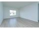 An empty bedroom showcasing hardwood floors, a large window and neutral wall color at 995 Fiesta Key Cir, Lady Lake, FL 32159