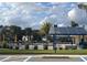 Community pool with a solar panel shade structure, a bathhouse, and palm trees at 995 Fiesta Key Cir, Lady Lake, FL 32159