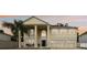 Charming two-story home with a three-car garage, columns, and a well-manicured lawn at sunset at 1454 Sterns Dr, Leesburg, FL 34748