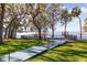 Lush backyard with a walkway leading to a private dock on the lake at 15749 Acorn Cir, Tavares, FL 32778