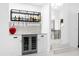 Modern bar area with wine refrigerator, glassware storage, and stylish decor at 15749 Acorn Cir, Tavares, FL 32778