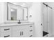 Elegant bathroom showcasing white vanity, black fixtures, large mirror, and glass-enclosed shower at 15749 Acorn Cir, Tavares, FL 32778