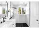 Modern bathroom featuring white marble tile, black shower fixtures, and a glass shower enclosure at 15749 Acorn Cir, Tavares, FL 32778