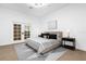 Bedroom featuring modern accents, stylish bedding, and French doors that provide lots of light at 15749 Acorn Cir, Tavares, FL 32778