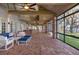 Large brick patio with ceiling fans, wood ceilings, generous seating and views of the lawn and lake at 15749 Acorn Cir, Tavares, FL 32778