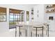 Bright dining area with water view, modern table, and elegant chairs at 15749 Acorn Cir, Tavares, FL 32778