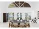 Elegant dining room with large windows and doors providing stunning water views at 15749 Acorn Cir, Tavares, FL 32778