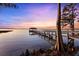 Waterfront property featuring a private dock and covered gazebo, perfect for enjoying scenic sunsets and lake views at 15749 Acorn Cir, Tavares, FL 32778