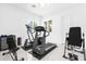 Home exercise room with treadmill, inversion table, and ample space for workouts at 15749 Acorn Cir, Tavares, FL 32778