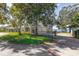 Beautifully landscaped home with manicured lawn, mature trees, circular driveway and gated entry at 15749 Acorn Cir, Tavares, FL 32778