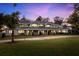 Sprawling gray single-Gathering home boasts a large manicured lawn and elegant architectural details at 15749 Acorn Cir, Tavares, FL 32778