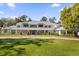 Expansive home boasts mature landscaping, a sprawling lawn and an inviting circular driveway at 15749 Acorn Cir, Tavares, FL 32778