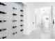 Bright hallway with white tile floors and wine storage, leading to staircase and other areas at 15749 Acorn Cir, Tavares, FL 32778