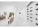 Bright hallway featuring white tile floors, wine storage, and views to other rooms at 15749 Acorn Cir, Tavares, FL 32778