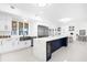 Bright kitchen with stainless steel appliances, white cabinets, and large island at 15749 Acorn Cir, Tavares, FL 32778