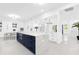 Spacious white kitchen with large navy island and quartz countertops at 15749 Acorn Cir, Tavares, FL 32778