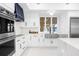 Modern kitchen features stainless steel appliances, white cabinets and luxury finishes at 15749 Acorn Cir, Tavares, FL 32778
