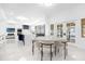 Open floor plan of kitchen and dining area offers ample space and modern design at 15749 Acorn Cir, Tavares, FL 32778