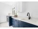 Well-organized laundry room featuring modern cabinets, countertops, and washer/dryer at 15749 Acorn Cir, Tavares, FL 32778