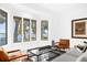 Cozy living room featuring bay window with water views, modern decor, and comfortable seating at 15749 Acorn Cir, Tavares, FL 32778