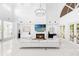 Spacious open-concept living room featuring high ceilings, a fireplace, and modern design elements at 15749 Acorn Cir, Tavares, FL 32778