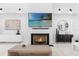Cozy living room with a fireplace, sleek modern decor, and a serene, minimalist aesthetic at 15749 Acorn Cir, Tavares, FL 32778
