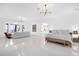 Spacious main bedroom suite featuring water views, sitting area, and modern furnishings at 15749 Acorn Cir, Tavares, FL 32778
