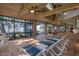 Spacious, sunlit brick patio with lounge chairs and serene lake views at 15749 Acorn Cir, Tavares, FL 32778