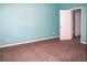 The bedroom has light blue walls, neutral carpet and a closet for storage at 2572 Limerick Cir, Grand Island, FL 32735