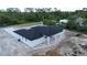 Aerial view of the home showing the back patio and the surrounding wooded landscape at 40327 Royal Trails Rd, Eustis, FL 32736
