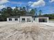 New construction home featuring modern design, black accents, and attached garage at 40327 Royal Trails Rd, Eustis, FL 32736