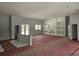 Open-concept living room featuring built-in shelves and large windows at 40327 Royal Trails Rd, Eustis, FL 32736
