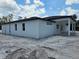 Exterior view of stucco home with a covered porch area at 40327 Royal Trails Rd, Eustis, FL 32736
