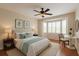 Cozy bedroom with bay windows, a ceiling fan, and warm, neutral tones at 9417 Se 132Nd Loop, Summerfield, FL 34491