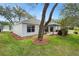 Well-maintained backyard with mature trees providing ample shade at 206 Desota Ct, The Villages, FL 32159