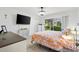Bright bedroom features a large window, ceiling fan, and neutral decor at 206 Desota Ct, The Villages, FL 32159