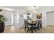 Bright dining room features an elegant chandelier, stylish decor, and views into the kitchen at 206 Desota Ct, The Villages, FL 32159