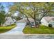 Charming single-Gathering home features mature trees, a two-car garage and beautifully landscaped front yard at 206 Desota Ct, The Villages, FL 32159
