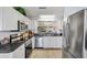 Modern kitchen features stainless steel appliances, bright white cabinets, and plenty of counter space at 206 Desota Ct, The Villages, FL 32159