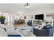 Open-concept living room with dining area, modern decor, and plenty of natural light at 206 Desota Ct, The Villages, FL 32159
