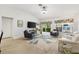 Bright, spacious living room with lots of seating, stylish decor, and lots of natural light at 206 Desota Ct, The Villages, FL 32159