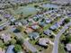 Aerial view of the property in a neighborhood with a lake and golf course in the background at 3360 Richmond Dr, The Villages, FL 32162